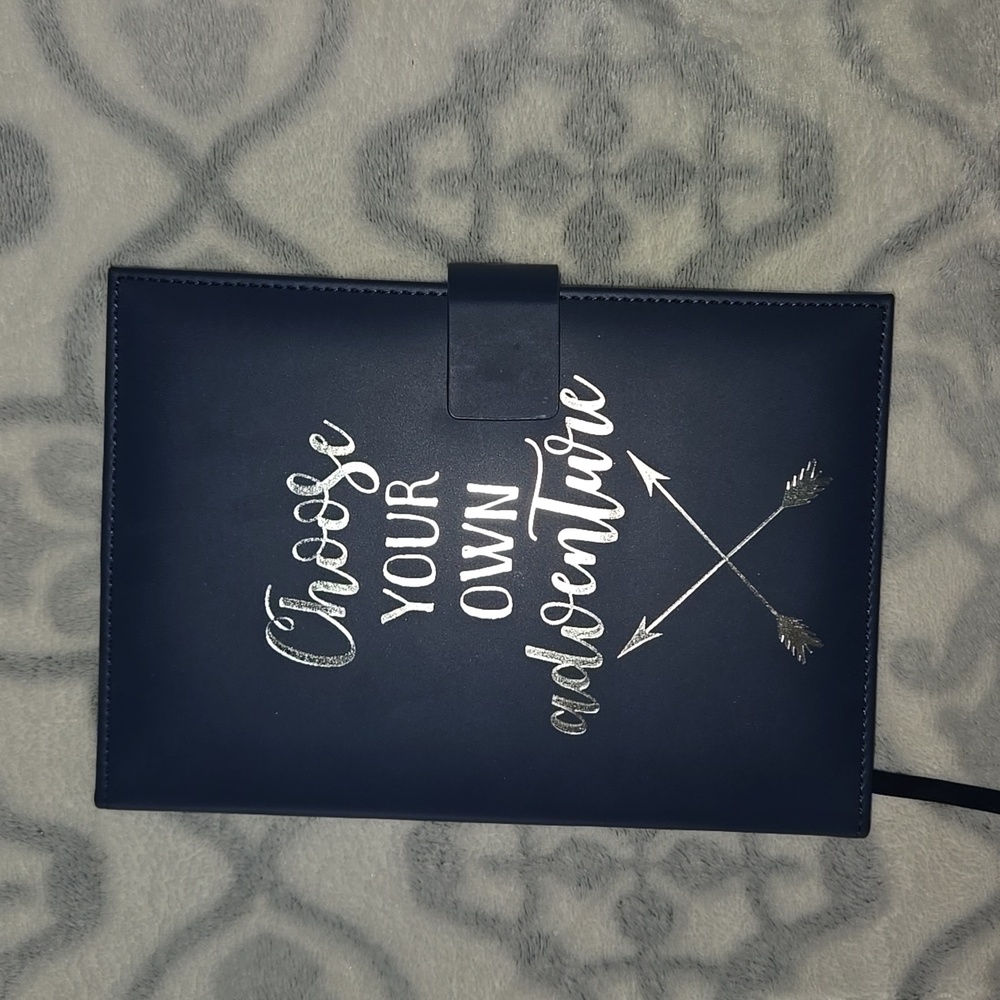 Faux leather magnet clasp closing wide ruled journal.